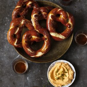 Bavarian pretzel served with Obatzda, a delicious cheese spread perfect for pretzels.